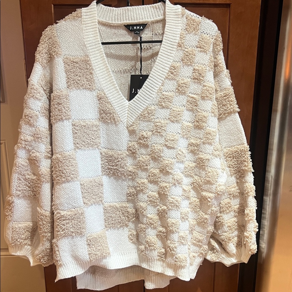 Cream and Tan V-Neck Checkered Sweater. Never worn. No rios or stains